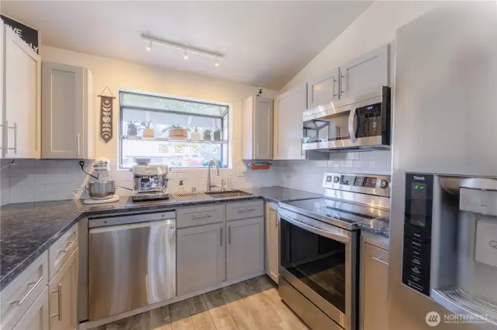 Beautifully updated Kitchen with stainless steel appliances and granite countertops