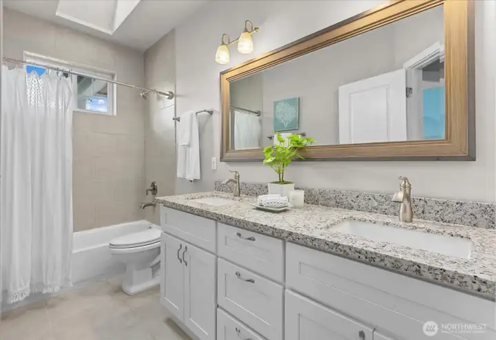 A well-appointed full bath features generous counter space and timeless finishes that blend style with practicality. A well-appointed full bath features generous counter space and timeless finishes that blend style with practicality.
