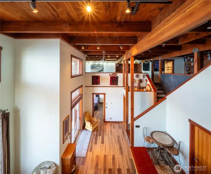 Looking at the lower level from the second floor with the incredible old-growth timbers and wood plank ceiling. Looking at the lower level from the second floor with the incredible old-growth timbers and wood plank ceiling.