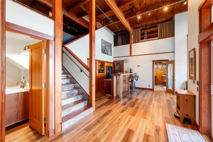 Looking at the lower level with the full bath to the left of the stairs and the steam room at the far end. The kitchen and recreational room is positioned to the center. Looking at the lower level with the full bath to the left of the stairs and the steam room at the far end. The kitchen and recreational room is positioned to the center.