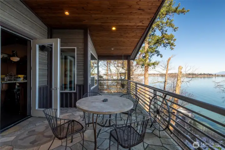 The flagstone deck is just off the dining room on the main level. The flagstone deck is just off the dining room on the main level.