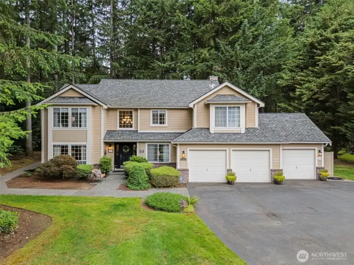 Beautifully maintained exterior featuring lush landscaping, mature evergreens,  spacious 3 car garage & a wide walkway to the back door! There's even room for a basketball hoop!