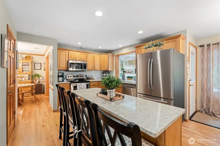 The heart of the home offers quartz countertops, abundant cabinetry and an oversized island perfect for gathering.