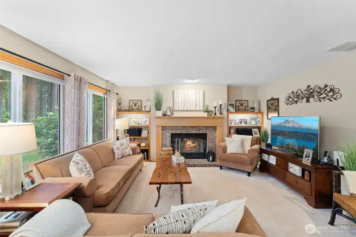 Inviting family room with a cozy gas fireplace framed by custom built-ins.