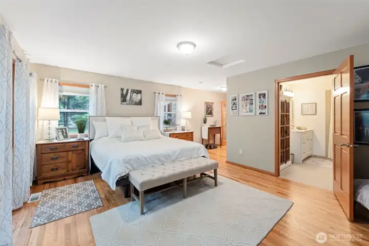 Spacious main floor primary suite features own ensuite with roll in shower & access to the back patio.