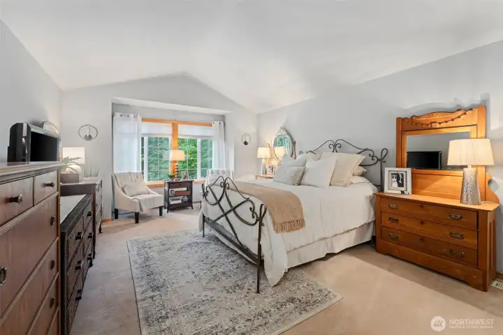 Expansive upstairs primary suite with vaulted ceilings & abundant natural light.