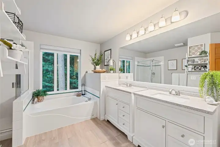 Updated 5-piece primary bath with dual vanities, soaking tub & walk-in shower.