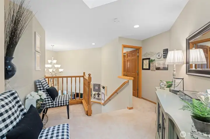Private upstairs sitting loft leads to the secluded primary suite!