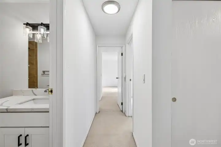Hallway connecting the bedrooms, bath, and living areas.