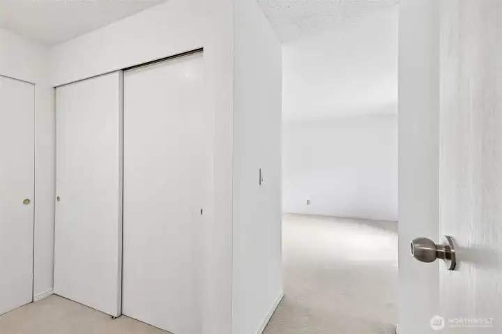Hall storage with sliding closet doors.