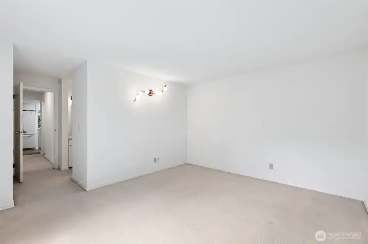 Flexible bonus room with natural light and adjacent hall access.