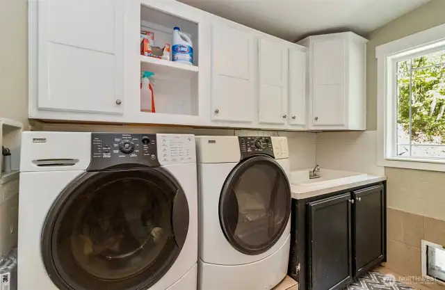 Laundry Room Complete with Cabinets~HE Front Loading Washer & Dryer on Risers~Double Utility Sink~Water Heater Closet~Double Strapped~Adjacent 1/2 Bath & Pet Door