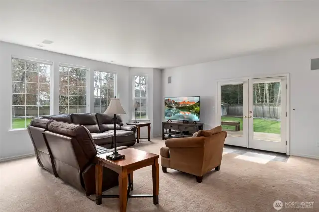 Large family room with french doors leading out to the deck & patio area overlooking the expansive private backyard!