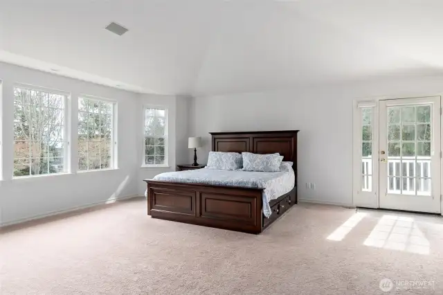 Double doors open to a huge primary bedroom suite with plenty of space for a king sized bed!