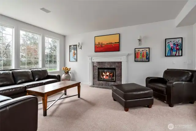 Spacious inviting living room with cozy gas fireplace.