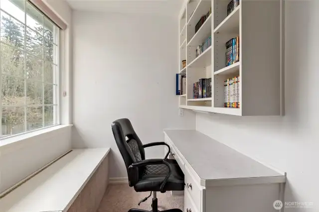 Bedroom #3 built-in desk area with shelves & window seat.