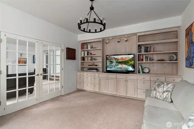 Office/den features a wall of built-in shelving.