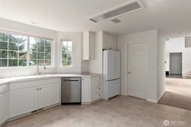 There is a walk-in pantry to the right of the refrigerator.