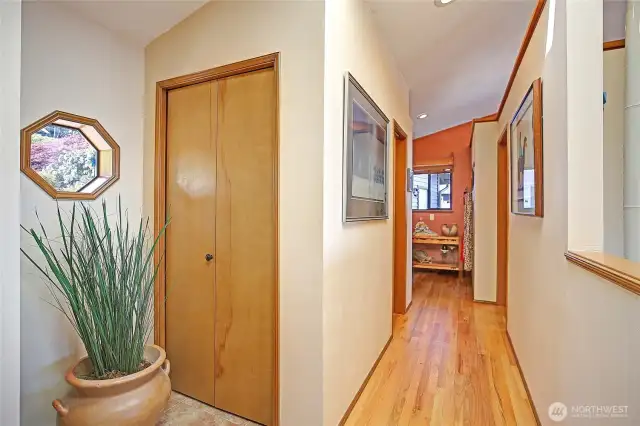 Entry coat closet, hallway leading to powder room, kitchen and garage...