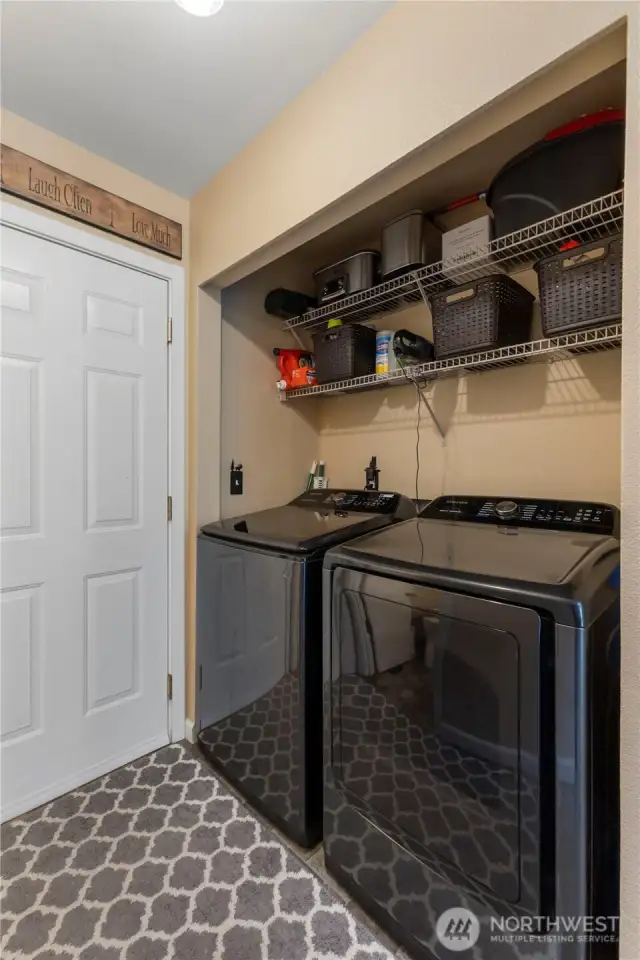 Laundry room located in between the garage entry and kitchen.