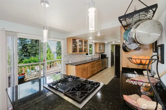Kitchen with Jenn-Air gas range and doors opening up to the deck for BBQing and outside dining.