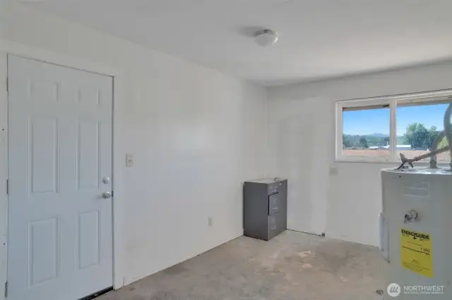 Laundry room with car port and kitchen entrance