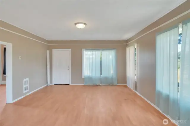 Looking at the living room with entrance to the primary bedroom on the left