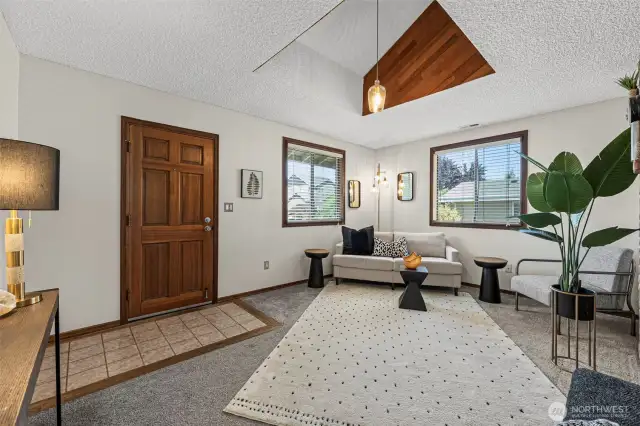 The entry features durable tiled flooring and elegant wood-wrapped windows that add a touch of classic charm and craftsmanship. A perfect blend of comfort and character!