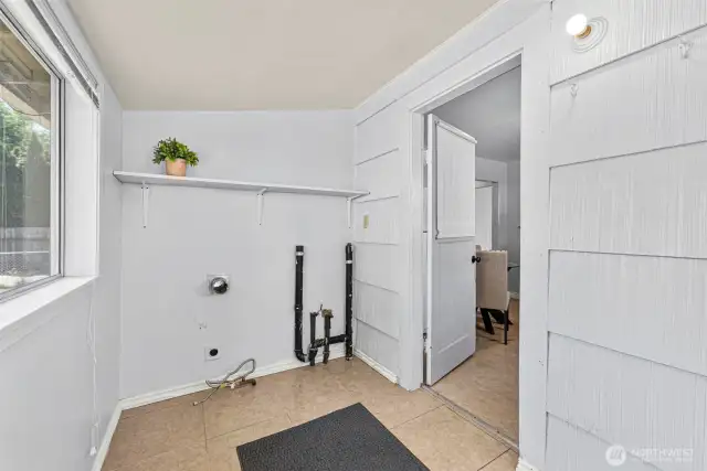 Just off the kitchen, you'll find a dedicated laundry/utility room that adds everyday convenience. With space for your washer, dryer, and extra storage, it’s the perfect spot to keep household tasks organized and out of sight.