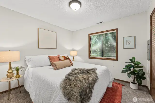 One of the two cozy bedrooms in this one-story charmer offers a peaceful retreat with soft natural light and comfortable space to unwind.