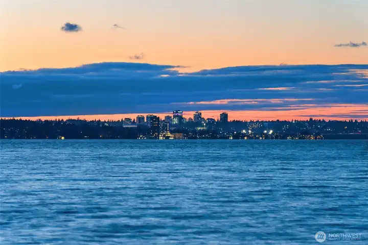 Enjoy serene west-facing views that stretch beyond the tip of Mercer Island to the glittering Seattle skyline, where tranquil waters meet the vibrant city lights.
