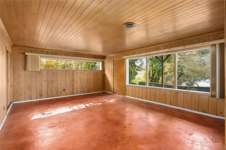 Spacious lower-level rec room featuring water views and a private separate entrance, offering flexibility for guests or extended living.