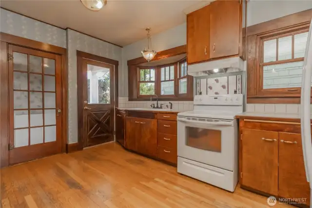 Convenient basement entrance off the kitchen with a door that keeps the light flooding in from outside.