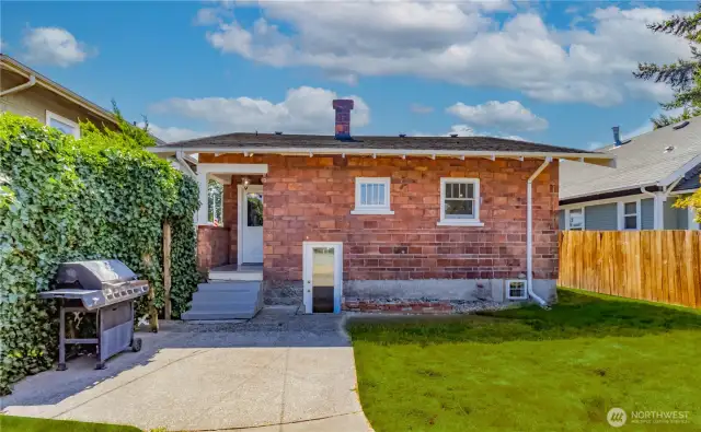 Ample space for backyard gatherings and fully fenced parking.(Grass is photo enhanced to green)