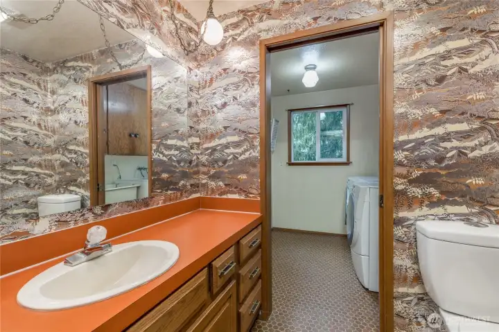 Half bath and laundry room with utility sink