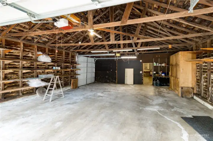 Roll-up door on the side offers access to the back field. Man door leads to the shop.