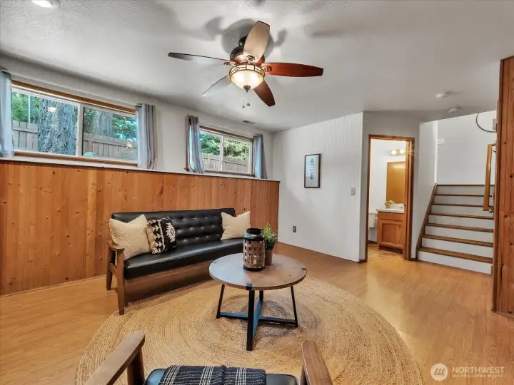 First level of home opens to additional living room or bonus room with half bath and laundry