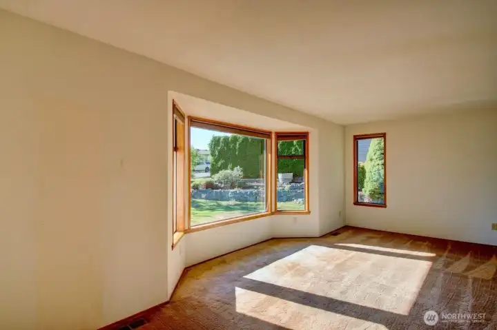 Living room with bay windows off the entry