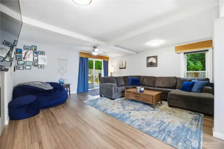 Living room with slider to Trex Deck and fully fenced yard