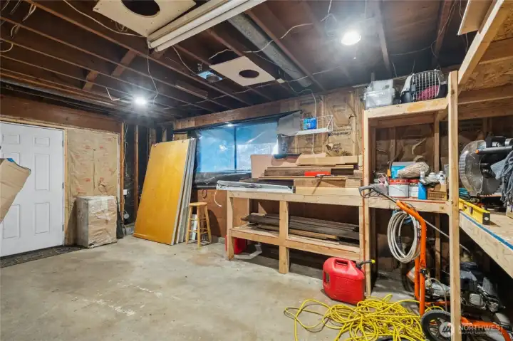 The versatile workshop space offers plenty of room for projects and hobbies, with the potential to be converted back into a garage if desired.
