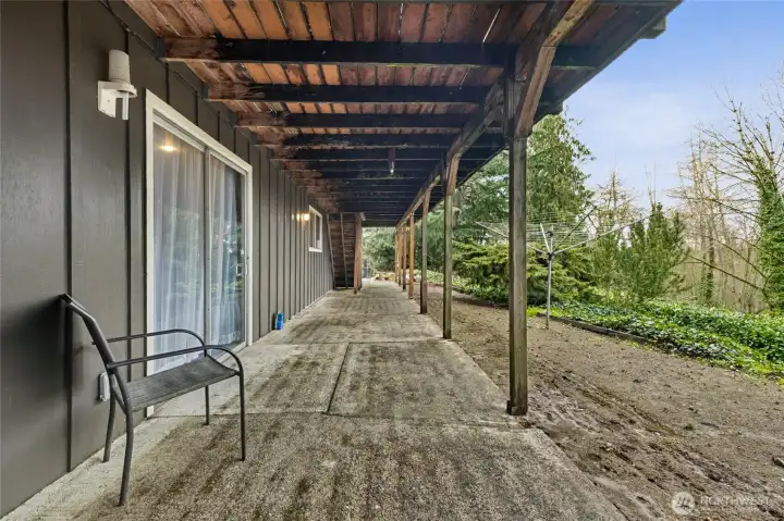 The lower-level patio offers an outdoor retreat, ideal for relaxing, entertaining, or enjoying the surrounding greenery and fresh air.