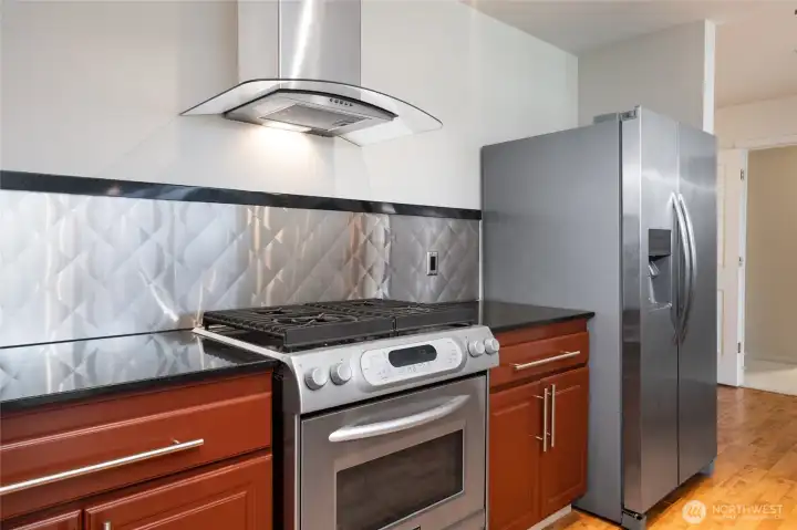 Stainless applilances and granite countertops with fine wood cabinets