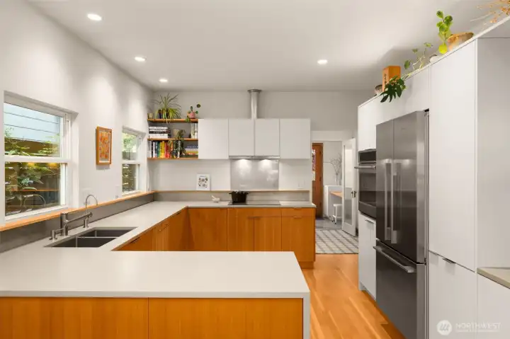 Designed to perfection with Fir cabinetry, induction cooktop, all new appliances, updated lighting fixtures, smooth skim coated drywall and new Fir floors.