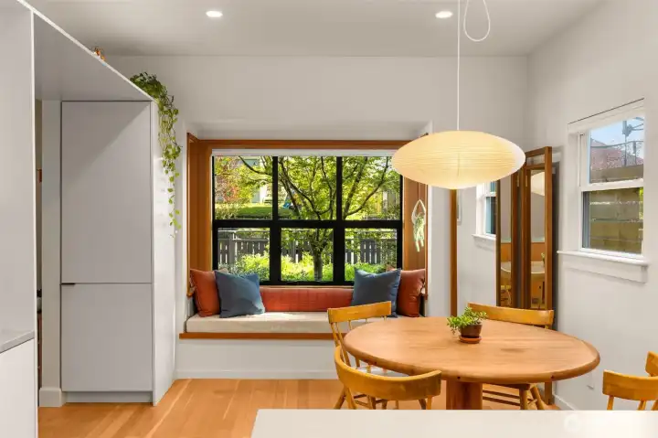 Dining room features a bump out nook overlooking the garden with new South-facing windows and custom cabinetry
