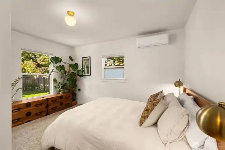 Large Primary Bedroom features Fir wood floors, mini split for heating and cooling, and a large closet. Window looks out into the private backyard.