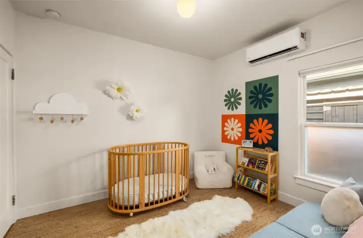 Secondary bedroom features new cork flooring, mini split for cooling and heating, and a closet.