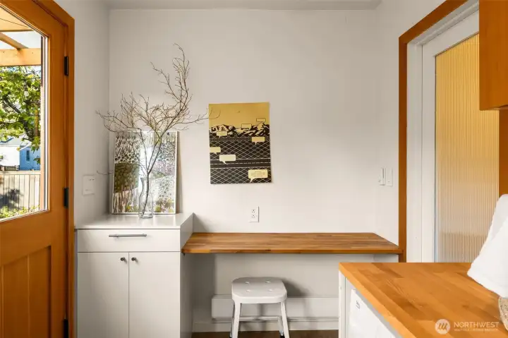 Custom built-in and removable desk in the flexspace that features the laundry, built-in bench and a half bath.