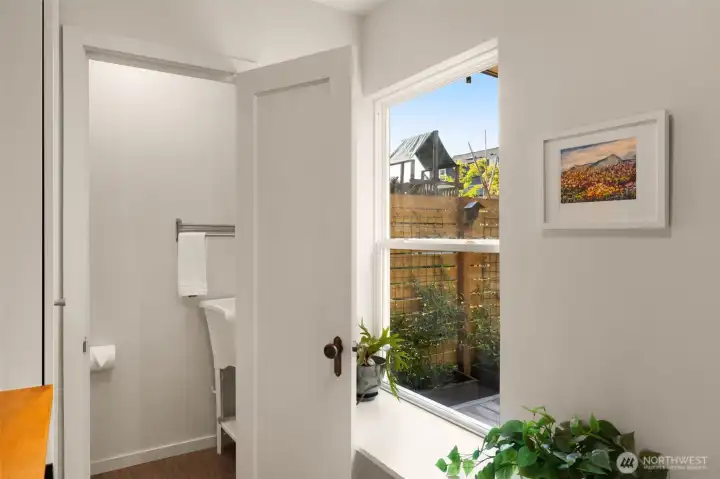 Half bath features a new toilet and a solid wood door that was replaced and salvaged.