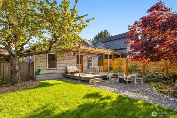 Backyard features mature trees: Rainier cherry, Japanese Maple, Dogwood