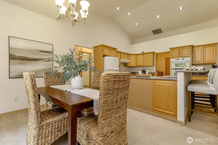 Dining room looking into kitchen and down hallway to other two bedrooms.